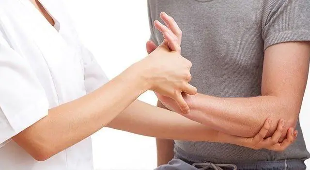 Doctor examining finger joints